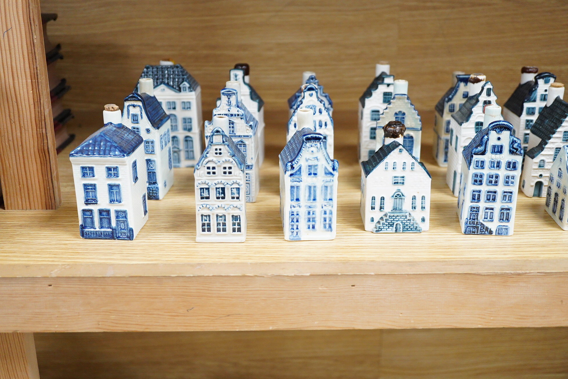 A collection of twenty seven KLM Delft blue miniature houses presented to Business class passengers together with a Delft jug - 20.5cm high